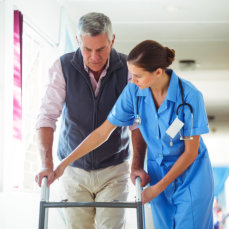 nurse guiding her patient in walking