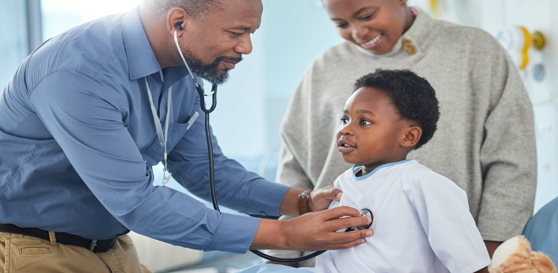 male doctor diagnosing a child